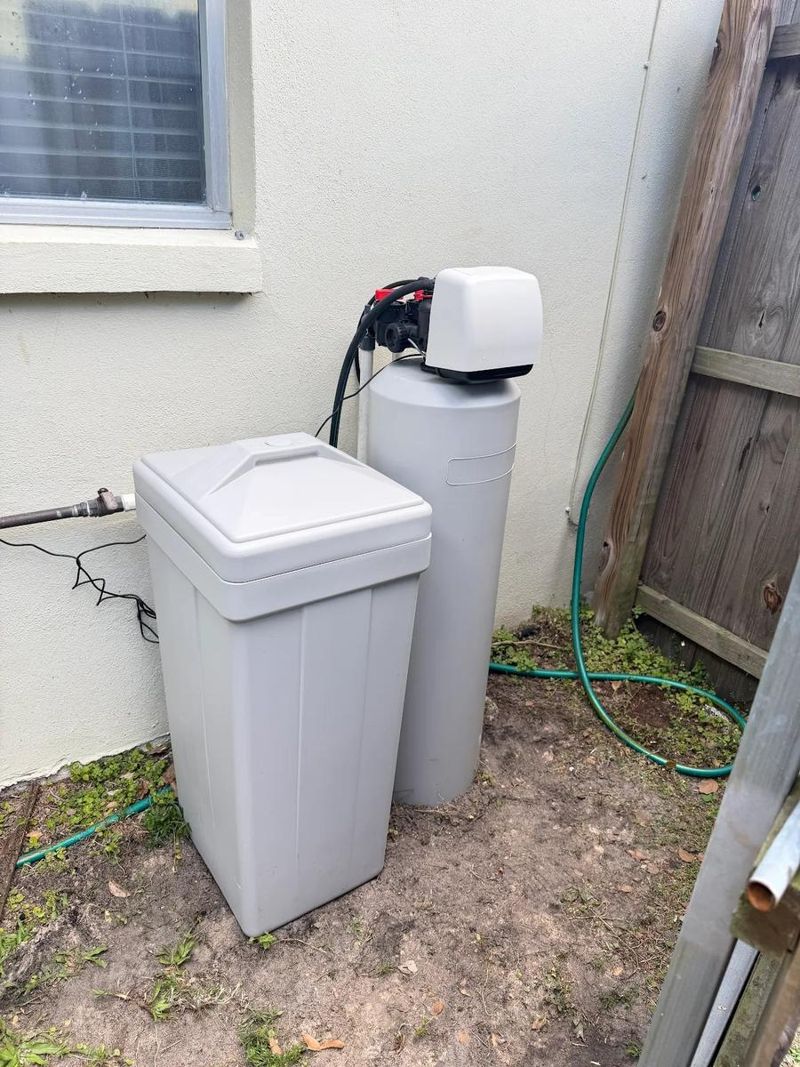 Water softener and brine tank installed beside a Florida home